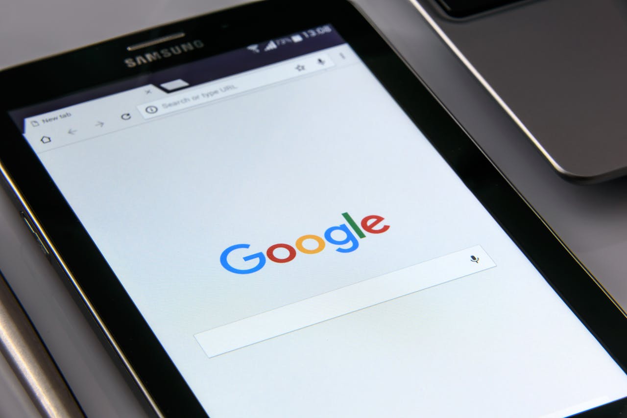 services-04 Close-up of a tablet displaying Google's search screen, emphasizing technology and internet browsing.